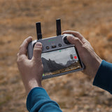 DJI RC 2 remote controller being operated with built-in touchscreen